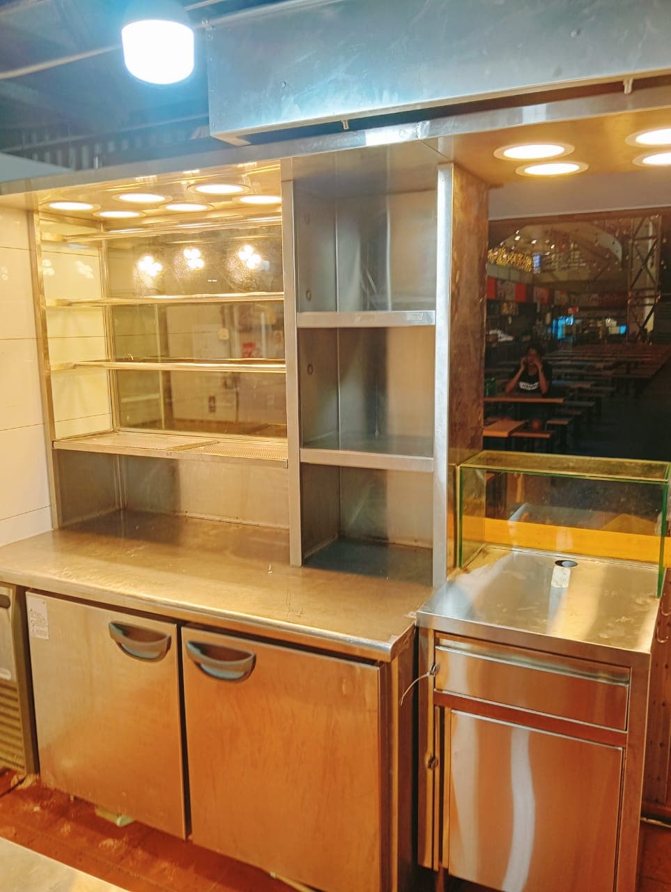 Undercounter double-door chiller with glass display shelving installed at a foodcourt stall
